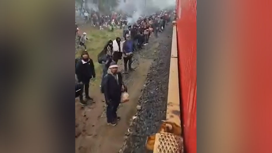 Thousands of migrants wait a few hours south of Eagle Pass, Texas, to catch trains headed for southern border