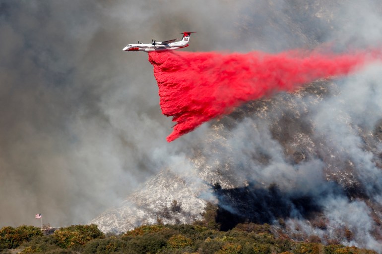 Firefighters race to contain LA wildfires as winds expected to pick up Firefighters race to contain LA wildfires as winds expected to pick up