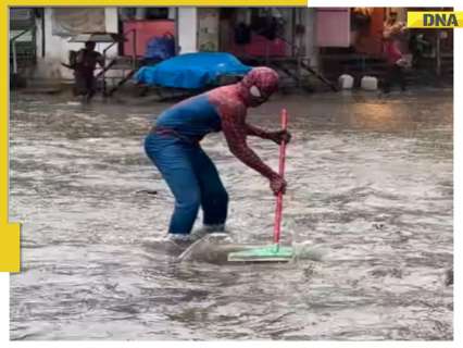 Spider-Man arrives to rescue Mumbaikars! Viral video shows a masked man draining waterlogged roads in Mumbai with a mop in hand – WATCH