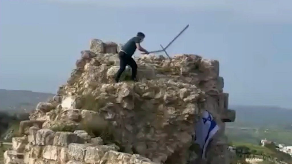 Lebanese man removes Israeli flag from castle in southern Lebanon
