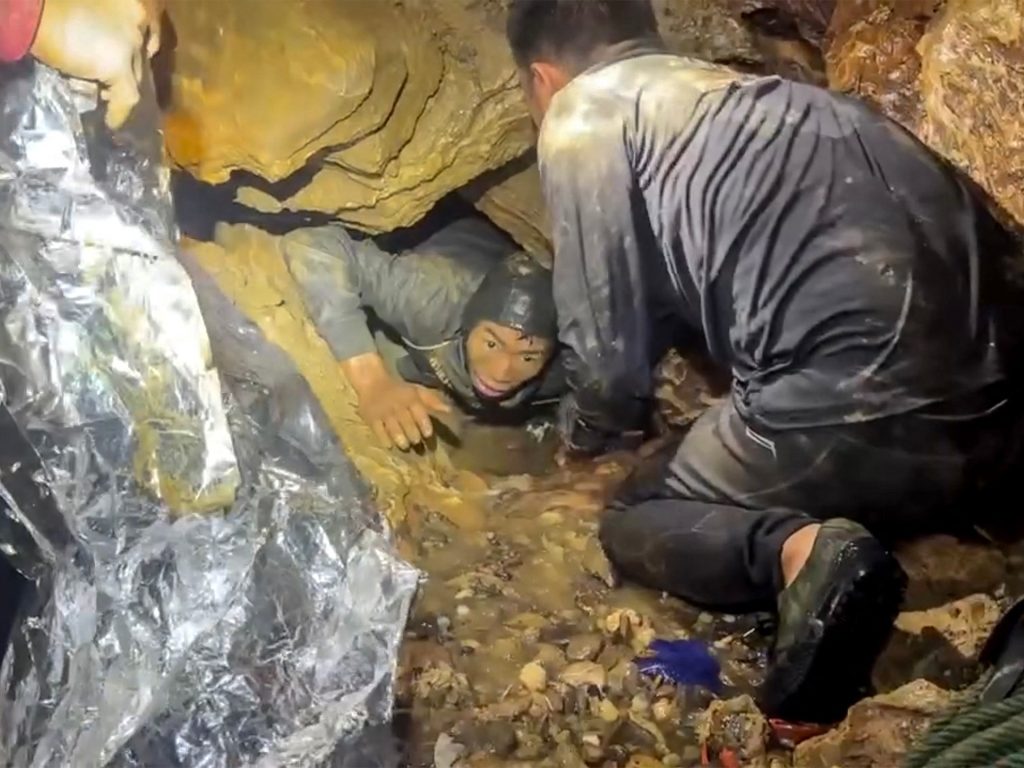 Rescuers race to save two people still trapped in cave in Laos Rescuers race to save two people still trapped in cave in Laos