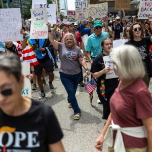 As Trump celebrates military, Texans protest president’s aggressive immigration enforcement