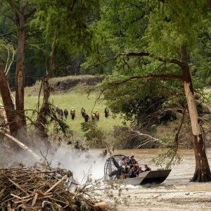 Search for flood victims slowed by mountains of debris as thousands descend on Kerr County to assist