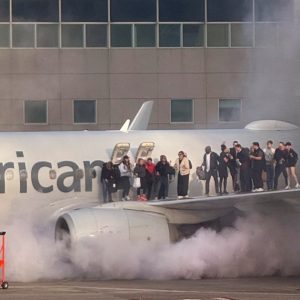 Passengers evacuate after American Airlines plane catches fire in Denver