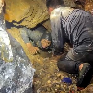 Rescuers race to save two people still trapped in cave in Laos